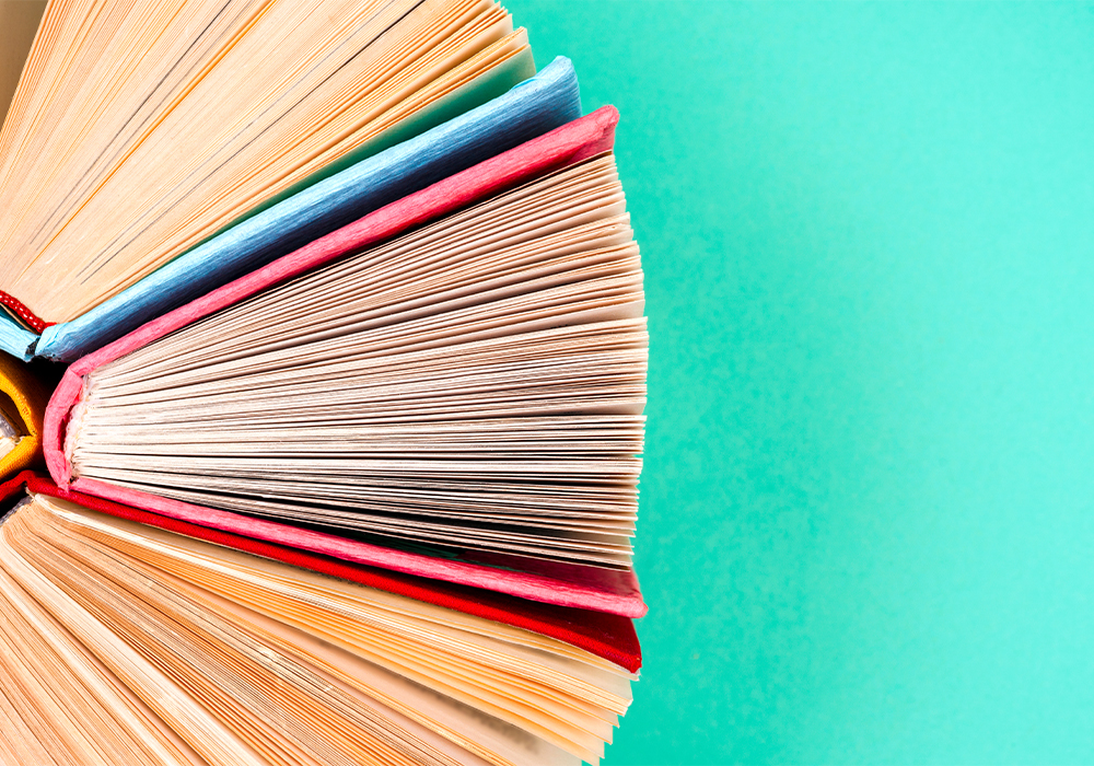 A circle of hardcover books against a green background.